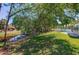 Backyard area with a pond view, mature trees, and access to the screened-in lanai at 823 Wooddusk Dr, Port Orange, FL 32127