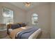 Bright bedroom featuring large windows, ceiling fan, and neutral decor at 823 Wooddusk Dr, Port Orange, FL 32127