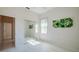 Bright bedroom with mirrored closet doors and light wood-look floors at 823 Wooddusk Dr, Port Orange, FL 32127