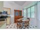 Charming dining area with a wooden table set, hutch, and natural light from a large window at 823 Wooddusk Dr, Port Orange, FL 32127