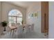 Bright dining room with modern decor, light floors, and natural light from a large window at 823 Wooddusk Dr, Port Orange, FL 32127