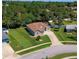 Aerial view showcasing the manicured lawn and landscaping of a single-story home at 823 Wooddusk Dr, Port Orange, FL 32127