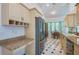 Cozy kitchen with tan cabinets, stainless steel appliances, and a charming breakfast nook with views at 823 Wooddusk Dr, Port Orange, FL 32127