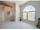 Bright living room featuring light floors, a large arched window, and neutral wall paint at 823 Wooddusk Dr, Port Orange, FL 32127