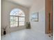 Bright living room featuring light floors, a large arched window, and neutral wall paint at 823 Wooddusk Dr, Port Orange, FL 32127