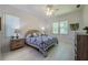 Comfortable main bedroom featuring ample natural light, ceiling fan, and neutral decor at 823 Wooddusk Dr, Port Orange, FL 32127