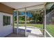 Screened patio with lake view, great for relaxing and enjoying the outdoors at 823 Wooddusk Dr, Port Orange, FL 32127