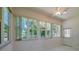 Inviting sun room filled with natural light from large windows, offering serene views of the outdoors at 823 Wooddusk Dr, Port Orange, FL 32127