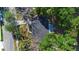 Aerial view of property with a large, dark asphalt driveway at 825 Baltimore Dr, Orlando, FL 32810