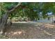 Large backyard featuring a covered porch, mature trees, and plenty of shade at 825 Baltimore Dr, Orlando, FL 32810