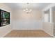Charming dining room features wainscoting and a chandelier at 825 Baltimore Dr, Orlando, FL 32810