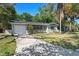 Charming home featuring an attached garage, lush landscaping, and a well-manicured lawn at 825 Baltimore Dr, Orlando, FL 32810