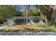 Charming single-story home with a well-maintained lawn and mature landscaping at 825 Baltimore Dr, Orlando, FL 32810
