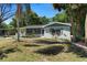 Charming home with manicured front lawn, beautiful plants, and lovely curb appeal at 825 Baltimore Dr, Orlando, FL 32810