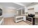 Well-lit kitchen with modern appliances, white cabinets, and ample countertop space at 825 Baltimore Dr, Orlando, FL 32810