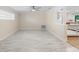 Light and airy living room with tile floors and view into the kitchen at 825 Baltimore Dr, Orlando, FL 32810
