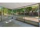 Spacious screened-in patio offering views of the property's lush backyard and mature landscaping at 825 Baltimore Dr, Orlando, FL 32810