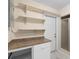 Functional utility room featuring a countertop, cabinets, shelves, and a shower at 825 Baltimore Dr, Orlando, FL 32810