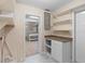 Bright utility room with cabinet, shelving, and doorway leading to another space at 825 Baltimore Dr, Orlando, FL 32810
