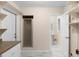 Convenient utility room with shower, sink, cabinet, and shelving; doorway to another space at 825 Baltimore Dr, Orlando, FL 32810