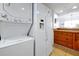 Kitchen featuring a stackable washer/dryer and white refrigerator at 89 S Atlantic Ave # 505, Ormond Beach, FL 32176