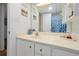 Bathroom with white cabinets, light counters, and shower with starfish curtain at 89 S Atlantic Ave # 505, Ormond Beach, FL 32176