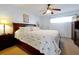 Bright bedroom with palm tree bedding and a ceiling fan at 89 S Atlantic Ave # 505, Ormond Beach, FL 32176