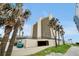 A condominium tower surrounded by mature palm trees, providing a resort-like ambiance at 89 S Atlantic Ave # 505, Ormond Beach, FL 32176