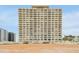 Large beachfront condo building showcasing multiple floors with many balcony views at 89 S Atlantic Ave # 505, Ormond Beach, FL 32176