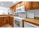 Well-maintained kitchen featuring wood cabinets, counter space, and essential appliances at 89 S Atlantic Ave # 505, Ormond Beach, FL 32176
