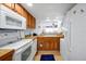 Efficient kitchen layout with white appliances, tiled floors, and a view to the water at 89 S Atlantic Ave # 505, Ormond Beach, FL 32176