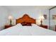 Close up of the main bedroom featuring a decorative headboard and lamps at 89 S Atlantic Ave # 505, Ormond Beach, FL 32176
