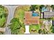 Aerial view of a home featuring a private pool with screened enclosure and well-maintained landscaping at 1 Cobblestone Trl, Ormond Beach, FL 32174