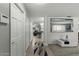 Hallway featuring tile flooring, white doors, and a large mirror for an open feel at 1 Cobblestone Trl, Ormond Beach, FL 32174