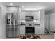 Modern kitchen with stainless steel appliances, granite countertops, and ample cabinet space at 1 Cobblestone Trl, Ormond Beach, FL 32174