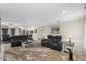 Spacious living room with leather seating and plush rug, ideal for relaxing and entertaining guests at 1 Cobblestone Trl, Ormond Beach, FL 32174