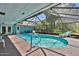 Enjoy the Florida sunshine in this screened-in private pool with attached lounge chairs at 1 Cobblestone Trl, Ormond Beach, FL 32174