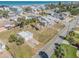 An aerial view of a two-story home, detached garage, and palm trees near a neighborhood street at 101 Egret Ave, Port Orange, FL 32127