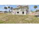 View of a two-story home with peeling paint, cinder block foundation, and sidewalks at 101 Egret Ave, Port Orange, FL 32127