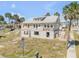 View of a two-story home with peeling paint, cinder block foundation, and sidewalk view at 101 Egret Ave, Port Orange, FL 32127