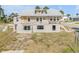 View of a two-story home with exterior showing peeling paint and cinder block foundation at 101 Egret Ave, Port Orange, FL 32127