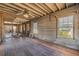 Hardwood flooring and exposed framing in a renovation project offering versatile design opportunities at 101 Egret Ave, Port Orange, FL 32127