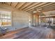 Hardwood flooring and exposed framing with lots of natural light showing renovation opportunities at 101 Egret Ave, Port Orange, FL 32127