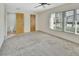 Bedroom with carpet, large windows, and ensuite bathroom access at 101 Grand Plaza Dr # A30, Orange City, FL 32763