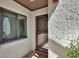 Condo entrance featuring a textured wall, screen door, and window with blinds at 101 Grand Plaza Dr # A30, Orange City, FL 32763
