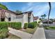 A sidewalk view of a lovely condo unit with manicured bushes and designated parking at 101 Grand Plaza Dr # A30, Orange City, FL 32763
