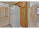 Kitchen with white refrigerator and wooden cabinets, adjacent to a dining area at 101 Grand Plaza Dr # A30, Orange City, FL 32763