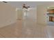 Open floor plan with tile flooring, ceiling fan, and view into the kitchen at 101 Grand Plaza Dr # A30, Orange City, FL 32763