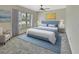Bright main bedroom featuring a blue bed, carpet, and a large window at 101 Grand Plaza Dr # A30, Orange City, FL 32763