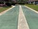 Outdoor shuffleboard courts with benches and manicured landscaping at 101 Grand Plaza Dr # A30, Orange City, FL 32763